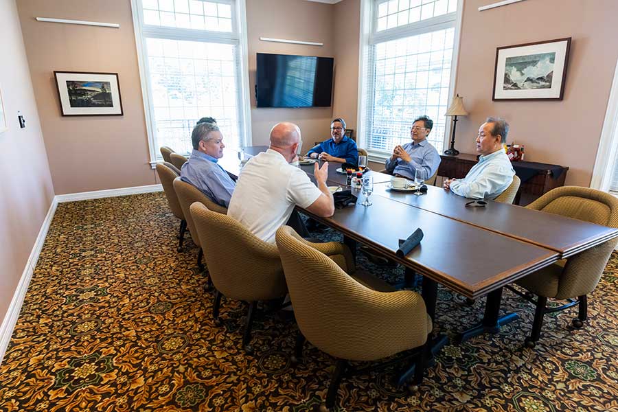 A group of people around a table in a meeting